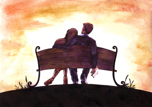 başını sevgilisin omzuna yaslamış kadın ve sevgilisi bankta oturuyor