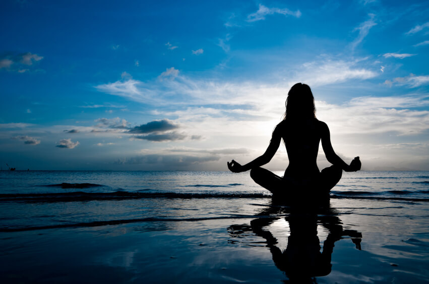 deniz kenarında meditasyon yapan kadın