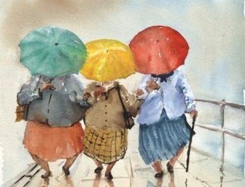 renkli şemsiyeler altında yürüyen kadınlar