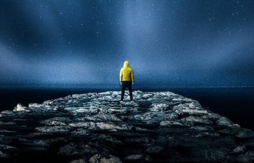 gece vakti kayalıkta duran bir adam
