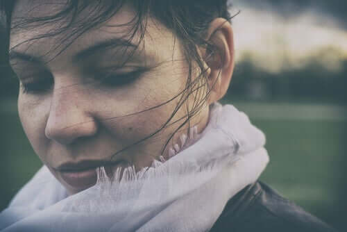 Rüzgarda saçları uçuşan atkılı kadın