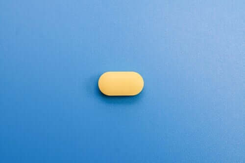 Mavi zamin üzerinde duran sarı bir ilaç.