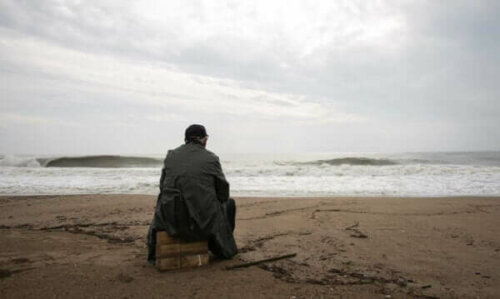deniz kenarında oturan adam